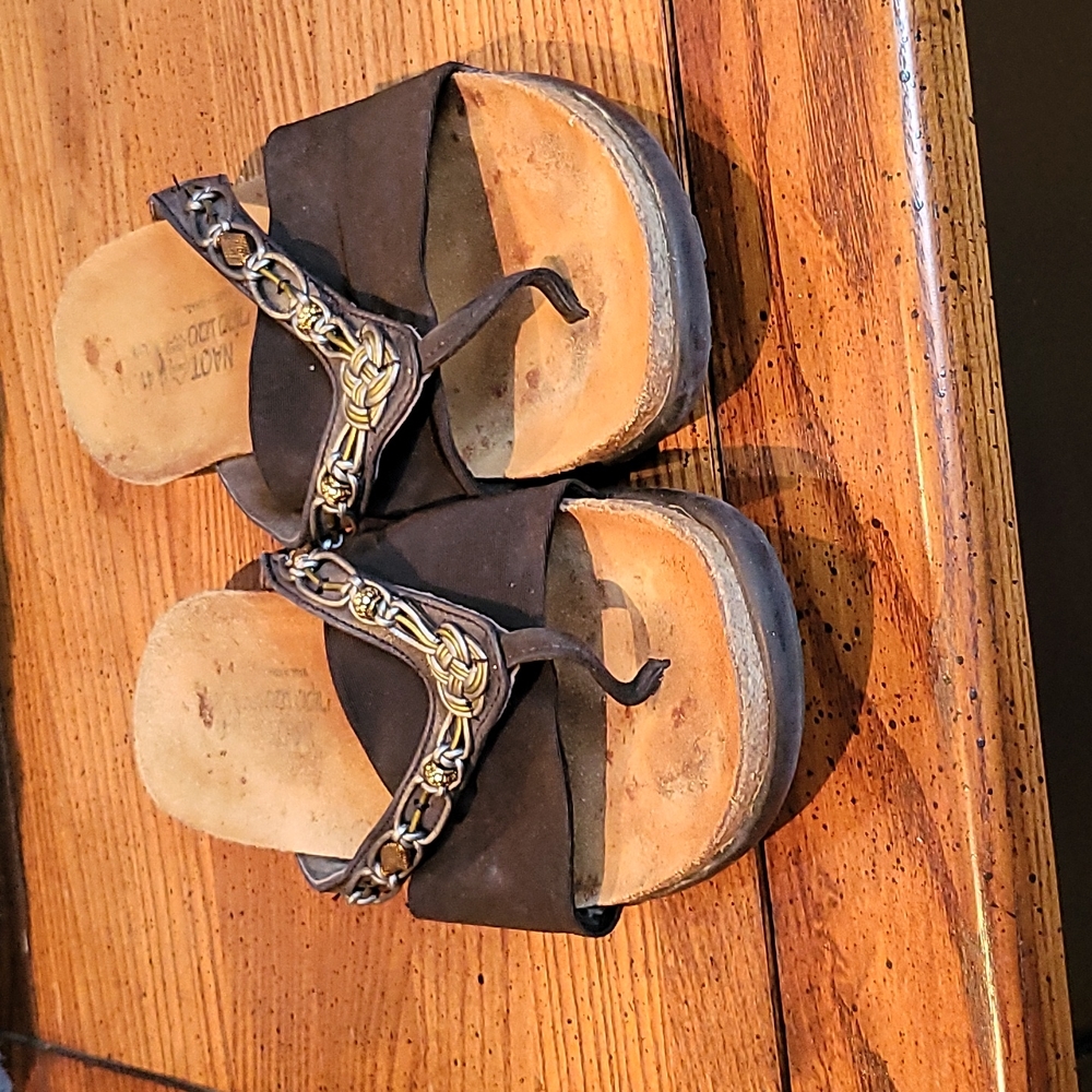 Naot brand, comfortable flat sandals, wide black elastic band across foot